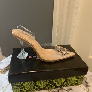Transparent closed toe, strapped heel.
